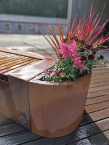 Cruach Design Garden Collection Corten Steel Iroko Hardwood Bench with curved Planters